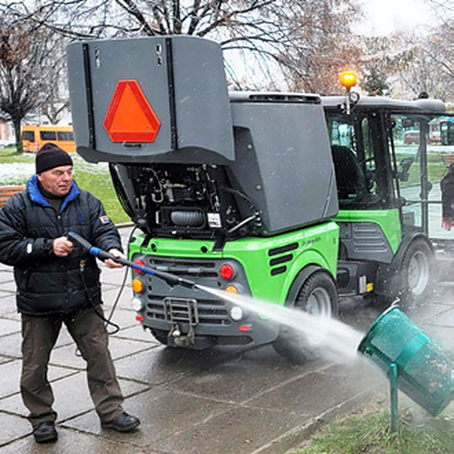 Operator myje zbiornik zamiatarki City Rangera 3070 myjką wysokociśnieniową z lancą